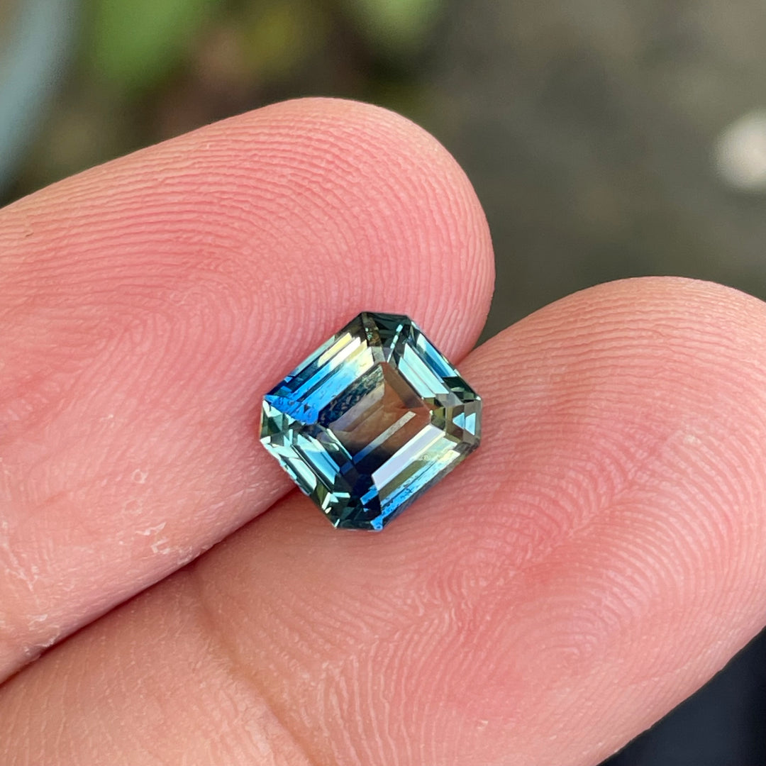 Natural 2.08 carat parti sapphire from Madagascar, cushion cut, unheated with a clean appearance, measuring 7.3 × 6.3 × 4.0 mm, loose earth-mined gemstone by Crystal Gem &amp; Jewelry.