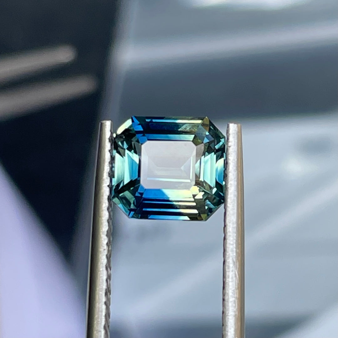 Natural 2.08 carat parti sapphire from Madagascar, cushion cut, unheated with a clean appearance, measuring 7.3 × 6.3 × 4.0 mm, loose earth-mined gemstone by Crystal Gem &amp; Jewelry.