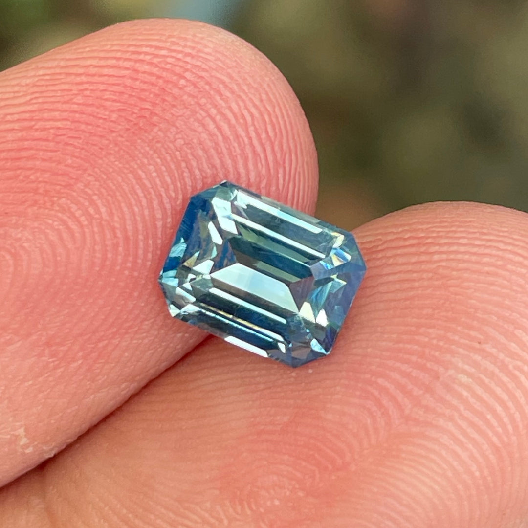 Natural 2.06 carat teal sapphire from Madagascar, emerald cut, unheated with a clean appearance, measuring 7.8 × 6 × 4.3 mm, loose earth-mined gemstone by Crystal Gem &amp; Jewelry.