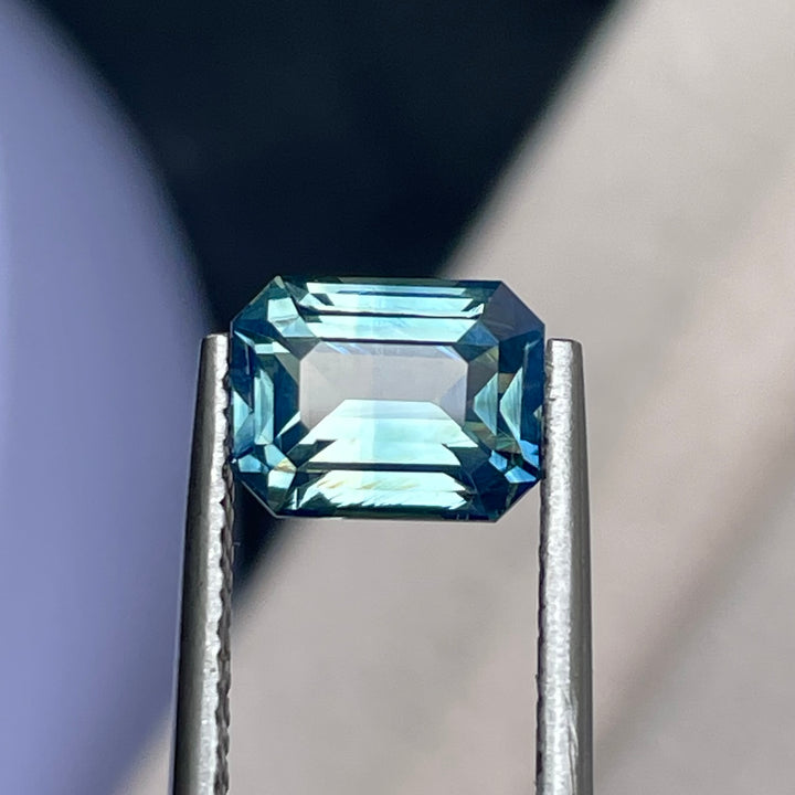 Natural 2.06 carat teal sapphire from Madagascar, emerald cut, unheated with a clean appearance, measuring 7.8 × 6 × 4.3 mm, loose earth-mined gemstone by Crystal Gem &amp; Jewelry.