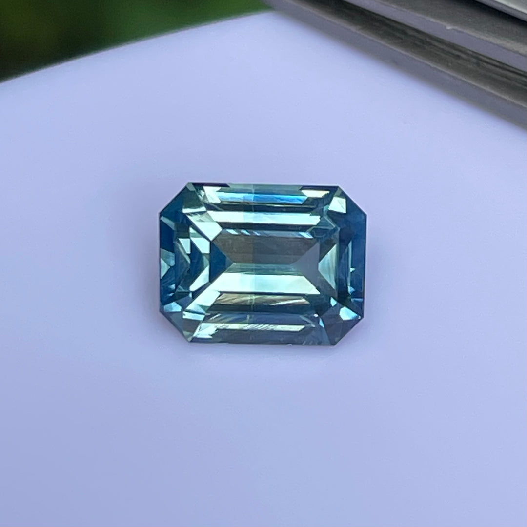 Natural 2.06 carat teal sapphire from Madagascar, emerald cut, unheated with a clean appearance, measuring 7.8 × 6 × 4.3 mm, loose earth-mined gemstone by Crystal Gem &amp; Jewelry.