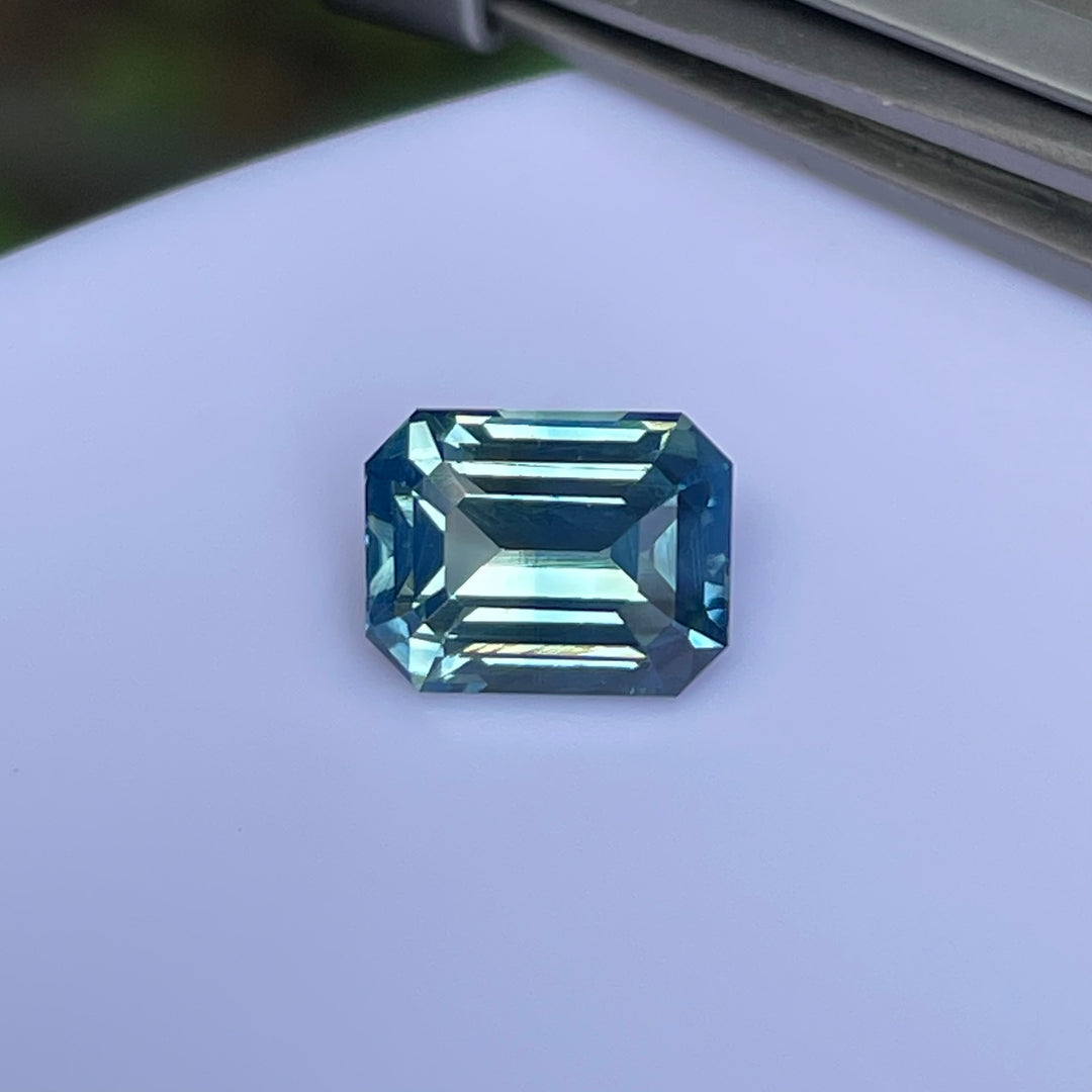 Natural 2.06 carat teal sapphire from Madagascar, emerald cut, unheated with a clean appearance, measuring 7.8 × 6 × 4.3 mm, loose earth-mined gemstone by Crystal Gem &amp; Jewelry.