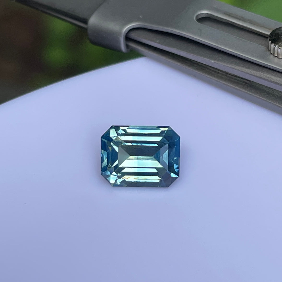 Natural 2.06 carat teal sapphire from Madagascar, emerald cut, unheated with a clean appearance, measuring 7.8 × 6 × 4.3 mm, loose earth-mined gemstone by Crystal Gem &amp; Jewelry.