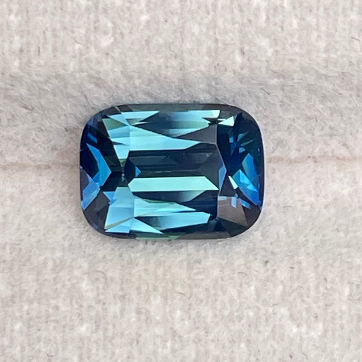 Natural 2.03 carat teal sapphire from Madagascar, radiant cut, unheated with a clean appearance, measuring 8 × 5.8 × 4.3 mm, loose earth-mined gemstone by Crystal Gem & Jewelry.